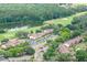 A high-angle view of the multi-building complex situated on a green landscape with lake and golf course views at 688 Midway Dr # B, Ocala, FL 34472