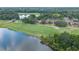 An aerial view of the golf course, pond, and multiple buildings on the property at 688 Midway Dr # B, Ocala, FL 34472