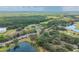 Panoramic aerial view of the property surrounded by lush greenery, lakes, and a golf course at 688 Midway Dr # B, Ocala, FL 34472