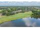 Aerial view of property with well-maintained landscaping and view of the nearby lake and golf course at 688 Midway Dr # B, Ocala, FL 34472