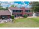 Expansive backyard featuring a well-maintained lawn, a patio with a grill, and a screened-in porch for outdoor living at 688 Midway Dr # B, Ocala, FL 34472