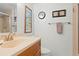 Simple, clean bathroom featuring a vanity and a shower with a towel rack and painted artwork at 688 Midway Dr # B, Ocala, FL 34472