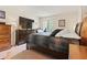 Comfortable bedroom featuring a dark wooden bed set, a TV, a window, and a neutral-colored carpet at 688 Midway Dr # B, Ocala, FL 34472