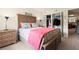 Well-lit bedroom featuring a wooden bed and furnishings and neutral-colored walls at 688 Midway Dr # B, Ocala, FL 34472
