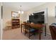 Dining room includes a dining table, chairs, a shelving unit, and a large screen television at 688 Midway Dr # B, Ocala, FL 34472