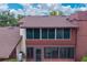 Close-up exterior view of a multi-story home with a screened-in porch and a well-maintained facade at 688 Midway Dr # B, Ocala, FL 34472