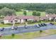 Low-angle view of a condominium complex showing the well maintained grounds and ample parking spaces at 688 Midway Dr # B, Ocala, FL 34472