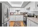 Bright kitchen boasts white cabinets, granite countertops, and modern stainless steel appliances at 688 Midway Dr # B, Ocala, FL 34472