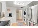 Contemporary kitchen showcasing stainless steel appliances, washer/dryer, and wood floors at 688 Midway Dr # B, Ocala, FL 34472