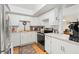 Bright kitchen featuring white cabinets, stainless steel appliances, and ample counter space at 688 Midway Dr # B, Ocala, FL 34472
