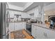 Well-lit kitchen features white cabinets, granite countertops and stainless steel appliances at 688 Midway Dr # B, Ocala, FL 34472