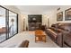Comfortable living room with furniture, a TV, and access to the outdoor patio at 688 Midway Dr # B, Ocala, FL 34472