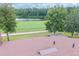 View of a red shingled roof with vents overlooking a pond and landscaped green space at 688 Midway Dr # B, Ocala, FL 34472