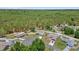 Aerial view of several homes surrounded by lush green trees and landscaping at 7 Pecan Drive Ter, Ocala, FL 34472