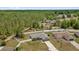 Aerial view of a home with a fenced yard, green grass and wooded area at 7 Pecan Drive Ter, Ocala, FL 34472