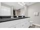 Bathroom with double sinks and black granite countertops over a white vanity at 7 Pecan Drive Ter, Ocala, FL 34472