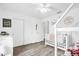 Bedroom with natural light, wood-look floors, closet, crib, and toddler bed at 7 Pecan Drive Ter, Ocala, FL 34472