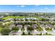 Picturesque aerial view of homes nestled by a calm lake, surrounded by lush green trees at 7263 Sw 99Th Cir, Ocala, FL 34481