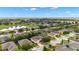 Expansive aerial view of a lovely community, featuring lush landscaping and a tranquil lake at 7263 Sw 99Th Cir, Ocala, FL 34481