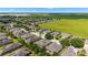 Aerial view of community homes adjacent to an open green field at 7263 Sw 99Th Cir, Ocala, FL 34481