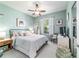 Bright bedroom with a ceiling fan, side table, dresser and mirror closet doors at 7263 Sw 99Th Cir, Ocala, FL 34481