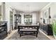 Well-lit dining room with contemporary furnishings, a decorative rug, and a view of the backyard through large windows at 7263 Sw 99Th Cir, Ocala, FL 34481