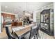 Open-concept dining room with stylish table, chairs, decor, and modern chandelier, flowing into kitchen area at 7263 Sw 99Th Cir, Ocala, FL 34481