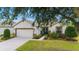 Attractive single-story house showcasing a 2-car garage, lush lawn, and a beautifully landscaped front yard at 7263 Sw 99Th Cir, Ocala, FL 34481