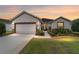 Charming single-story home featuring a 2-car garage, manicured lawn, and welcoming front entrance at 7263 Sw 99Th Cir, Ocala, FL 34481