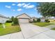 Inviting single-story home boasts a two-car garage, well-kept lawn, and charming landscaping at 7263 Sw 99Th Cir, Ocala, FL 34481