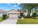 Inviting single-story home boasts a two-car garage, well-kept lawn, and charming landscaping at 7263 Sw 99Th Cir, Ocala, FL 34481