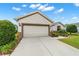 Lovely single-story residence with a two-car garage, manicured lawn, and an inviting facade at 7263 Sw 99Th Cir, Ocala, FL 34481