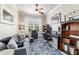 Home office space with a comfortable sofa, area rug, built-in shelves and a desk at 7263 Sw 99Th Cir, Ocala, FL 34481