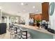 Kitchen with breakfast bar and seating, stainless appliances, leading to the dining area at 7263 Sw 99Th Cir, Ocala, FL 34481