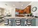 Kitchen view with stainless appliances, breakfast bar, and warm wood cabinetry, seating for three at 7263 Sw 99Th Cir, Ocala, FL 34481