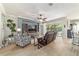 Cozy living room featuring a modern entertainment center, comfortable seating, and easy access to the outdoor patio at 7263 Sw 99Th Cir, Ocala, FL 34481