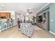 Bright and airy living room with hardwood floors, comfortable seating, and seamless flow to the kitchen area at 7263 Sw 99Th Cir, Ocala, FL 34481