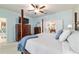 Spacious main bedroom featuring a four-poster bed, ceiling fan and ensuite bathroom with double vanity at 7263 Sw 99Th Cir, Ocala, FL 34481