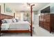 Bright main bedroom with large window, four poster bed, TV and chest of drawers at 7263 Sw 99Th Cir, Ocala, FL 34481