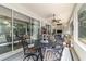 Covered patio offering an outdoor dining area and seating with a glimpse of the interior living space at 7263 Sw 99Th Cir, Ocala, FL 34481
