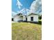 Side view of a charming single-story home with a well-maintained lawn and landscaping at 7292 Hemlock Loop, Ocala, FL 34472