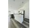 Modern kitchen with stainless steel appliances and a large island perfect for entertaining at 7292 Hemlock Loop, Ocala, FL 34472