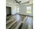 Spacious main bedroom featuring tray ceiling, new floors, and lots of natural light at 7292 Hemlock Loop, Ocala, FL 34472