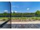 A paver patio leads to a lush backyard with privacy fence and manicured landscaping, under a sunny sky at 7987 Sw 89Th Cir, Ocala, FL 34481