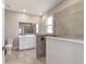 Modern bathroom featuring a walk-in shower with tile surround and a dual sink vanity at 7987 Sw 89Th Cir, Ocala, FL 34481