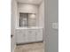 Bathroom featuring a large mirror, vanity with storage, and neutral paint at 7987 Sw 89Th Cir, Ocala, FL 34481