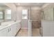 Sleek bathroom with dual sinks, a large mirror, and a glass-enclosed walk-in shower at 7987 Sw 89Th Cir, Ocala, FL 34481