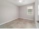 Neutrally painted bedroom featuring a ceiling fan, tile floor and a window at 7987 Sw 89Th Cir, Ocala, FL 34481