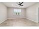 Well-lit bedroom with a ceiling fan, tile flooring, and neutral walls at 7987 Sw 89Th Cir, Ocala, FL 34481