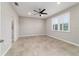 Spacious bedroom with tile flooring, ceiling fan, and a large window for natural light at 7987 Sw 89Th Cir, Ocala, FL 34481